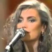 The lyrics LIKE STRANGERS of EMMYLOU HARRIS is also present in the album At the ryman (1992)