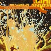 The lyrics THE WIZARD TURNS ON... THE GIANT SILVER FLASHLIGHT AND PUTS ON HIS WEREWOLF MOCCASINS of THE FLAMING LIPS is also present in the album At war with the mystics (2006)