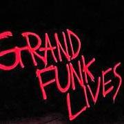 The lyrics STUCK IN THE MIDDLE of GRAND FUNK RAILROAD is also present in the album Grand funk lives (1981)
