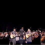 The lyrics WOODSONG of INDIGO GIRLS is also present in the album Indigo girls live with the university of colorado symphony orchestra (2018)